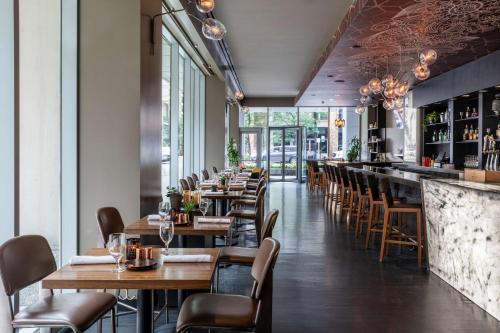 a restaurant with wooden tables and chairs and a bar at The Royal Sonesta Chicago River North in Chicago