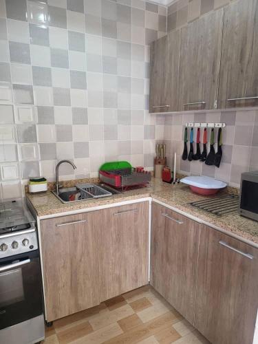 a kitchen with a sink and a counter top at The Perfect Place in Gwarinpa