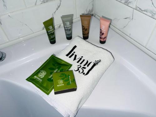 a bath tub with a towel and other products on it at Hotel Living 35 Suites in Medellín
