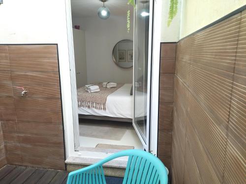 a small room with a bed and a glass door at Cais das Pedras Pátio Apartment - with washer and dryer machine in Porto