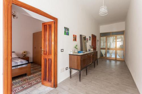 a bedroom with a bed and a dresser and a mirror at La Campidanese IUN R3640 in Càbras