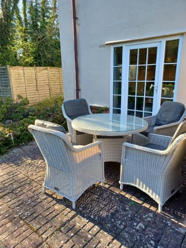 a patio with a table and four chairs at 5 The Martins in Walberswick