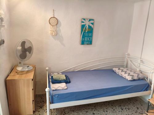 a small bedroom with a bed and a nightstand at Petrohori before midnight in Pylos