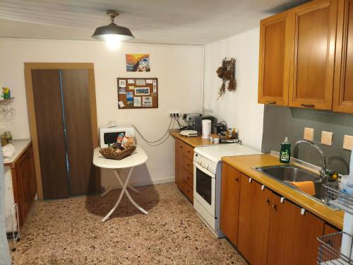 a kitchen with a sink and a table in it at Petrohori before midnight in Pylos