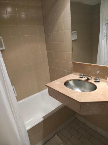 a bathroom with a sink and a bath tub at Tango BA in Buenos Aires