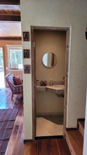 a bathroom with a sink and a mirror at Suítes La Reserve in Campos do Jordão