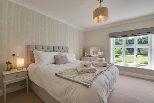 a bedroom with a large bed with towels on it at Bizewell Farmhouse in Trimingham