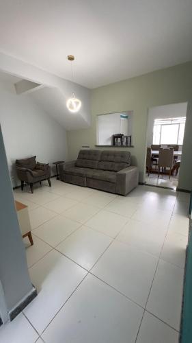 a large living room with a bed and a tiled floor at Casa 650m da Orla da Atalaia in Aracaju