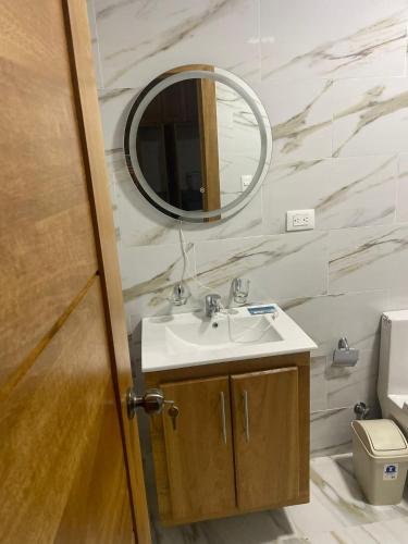 a bathroom with a sink and a mirror at res Montesino in San Felipe de Puerto Plata