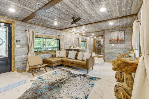 a living room with a couch and a table at Hike, Fish and Unwind Cabin with Yard in Broken Bow! in Broken Bow