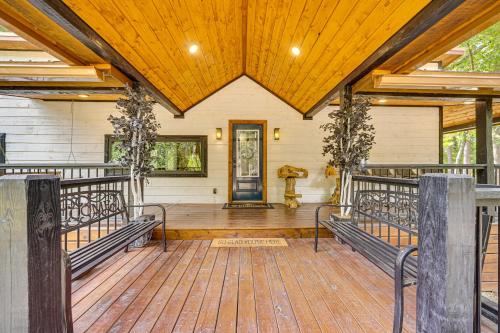 a porch with a wooden floor and a wooden ceiling at Hike, Fish and Unwind Cabin with Yard in Broken Bow! in Broken Bow