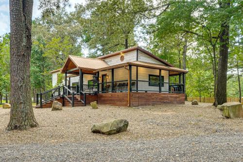 a small house in the middle of a forest at Hike, Fish and Unwind Cabin with Yard in Broken Bow! in Broken Bow