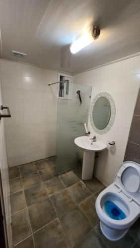 a bathroom with a toilet and a sink at 스테이 마산 in Changwon
