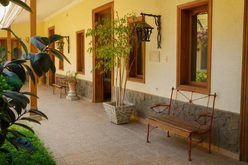 a bench sitting in front of a building at HOTEL HALLEY - Vicuña, Valle de Elqui in Vicuña
