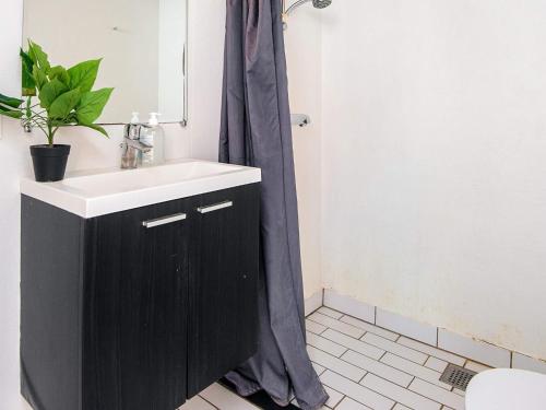 a bathroom with a black sink and a shower at 4 star holiday home in Hornsyld in Hornsyld