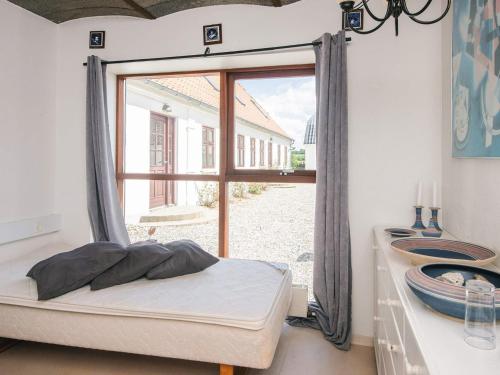 a bedroom with a bed and a large window at 4 star holiday home in Hornsyld in Hornsyld