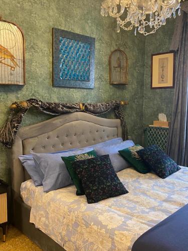 a bed with pillows on it in a bedroom at Venetian dream apartment in Venice