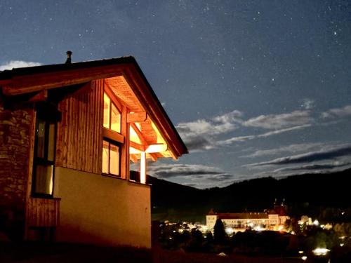 a house lit up at night with the sky at Grebenzen Lodge 1028 in Sankt Lambrecht