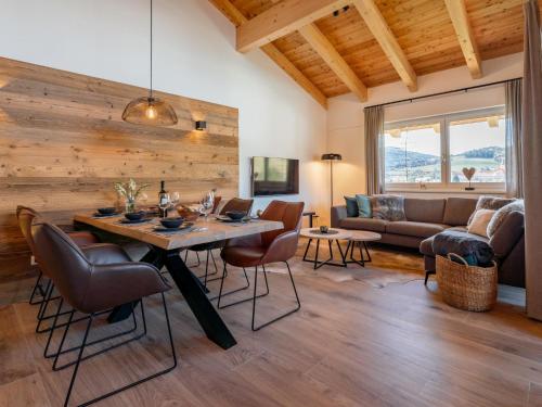 a living room with a table and chairs and a couch at Grebenzen Lodge 1028 in Sankt Lambrecht