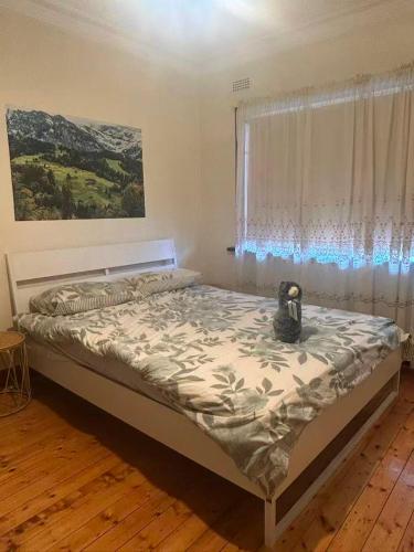 a bed in a room with a window and a bedvisor at Free Parking 5min Walk to Asian Supermarket Family Room Deakin Uni Quiet Camberwell in Camberwell