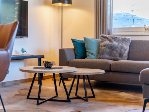 a living room with a couch and a table at Grebenzen Lodge 1028 in Sankt Lambrecht