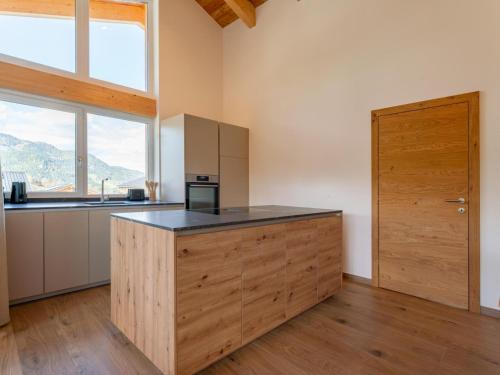 a kitchen with a wooden island with a counter top at Grebenzen Lodge 51 in Sankt Lambrecht