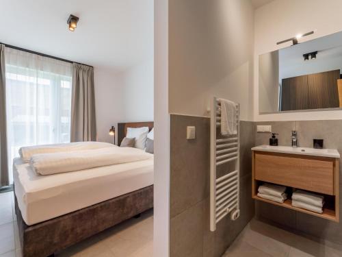 a bedroom with a bed and a sink at Grebenzen Lodge 55 in Sankt Lambrecht