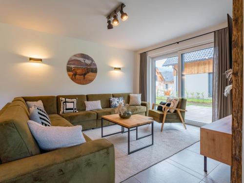 a living room with a couch and a table at Mountain Chalet An der Mur in Sankt Lorenzen ob Murau