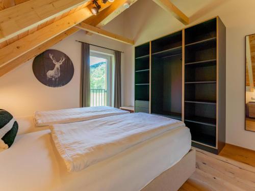 a bedroom with a large bed and a window at Mountain Chalet An der Mur in Sankt Lorenzen ob Murau