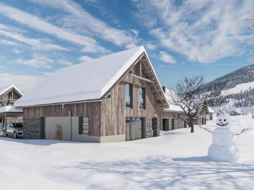 a snowman in front of a building in the snow at Mountain Chalet An der Mur in Sankt Lorenzen ob Murau