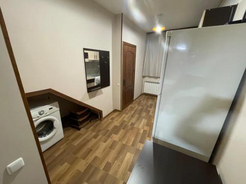 a kitchen with a washer and dryer in a room at Уютный дом in Yerevan