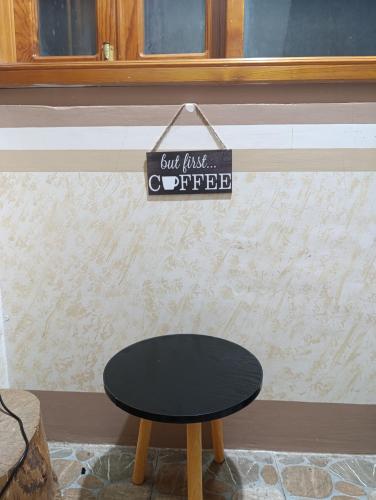 a table and a sign that says but first coffee at Sea of clouds view inn in Sagada