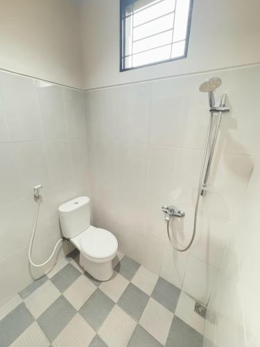 a bathroom with a toilet and a shower at Elbara Guest House Syariah in Banjarbaru
