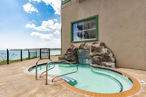 a swimming pool in front of a building at Amazing Superior Lake View Condo and Heated Pools in Two Harbors