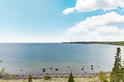 a view of a lake with birds in the water at Amazing Superior Lake View Condo and Heated Pools in Two Harbors