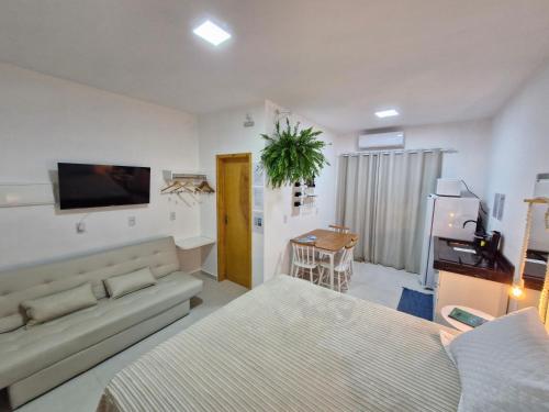 a living room with two beds and a couch at Palo Santo - Praia do Rosa in Praia do Rosa