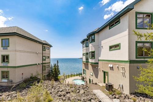an apartment building with a view of the water at Amazing Superior Lake View Condo and Heated Pools in Two Harbors
