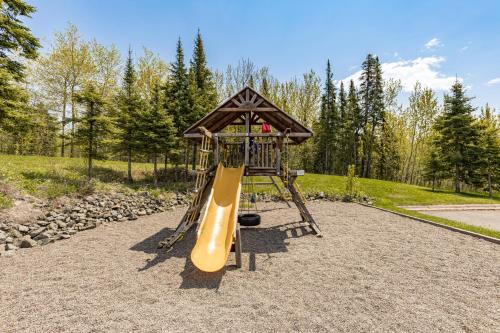 a playground with a slide in a park at Amazing Superior Lake View Condo and Heated Pools in Two Harbors