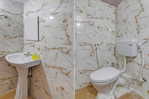 a bathroom with a toilet and a sink at OYO 82026 BANGUR INN in Nager Bazaar