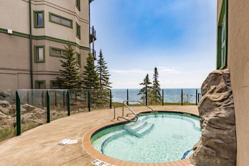 a swimming pool in front of a building at Amazing Superior Lake View Condo and Heated Pools in Two Harbors