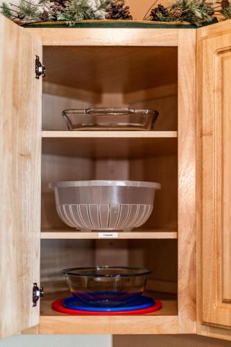 a cupboard with two bowls on a plate in it at Amazing Superior Lake View Condo and Heated Pools in Two Harbors