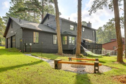 a black house with a hammock in front of it at 5 Mi to Stone Mountain Family Home in Lithonia