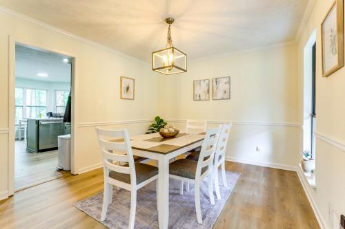 a dining room with a white table and chairs at 5 Mi to Stone Mountain Family Home in Lithonia