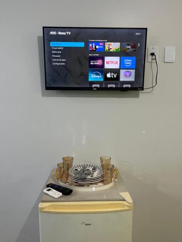 a flat screen tv sitting on top of a cabinet at Quarto privado próximo ao centro in Manaus