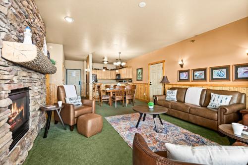 a living room with a couch and a fireplace at Amazing Superior Lake View Condo and Heated Pools in Two Harbors