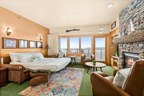 a living room with a bed and a fireplace at Amazing Superior Lake View Condo and Heated Pools in Two Harbors