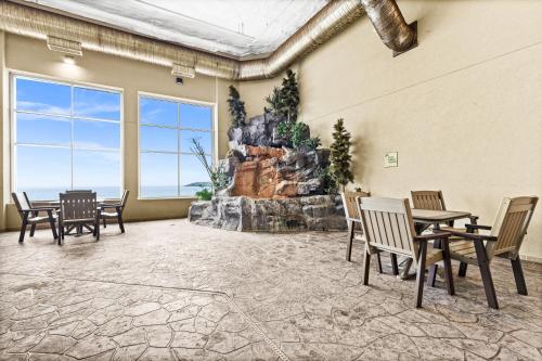 a room with a table and chairs and a rock wall at Amazing Superior Lake View Condo and Heated Pools in Two Harbors