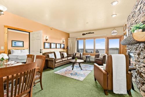 a living room with a couch and a table at Amazing Superior Lake View Condo and Heated Pools in Two Harbors