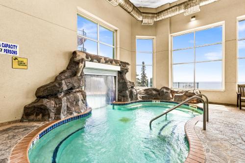 a swimming pool in a hotel with a water slide at Amazing Superior Lake View Condo and Heated Pools in Two Harbors