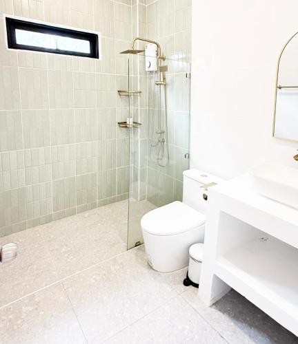 a bathroom with a shower and a toilet and a sink at Sri Thanu Escape 2 in Srithanu